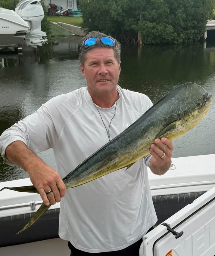 Scott Bodager, founder of Eagle Vision, holding a fresh catch on the water